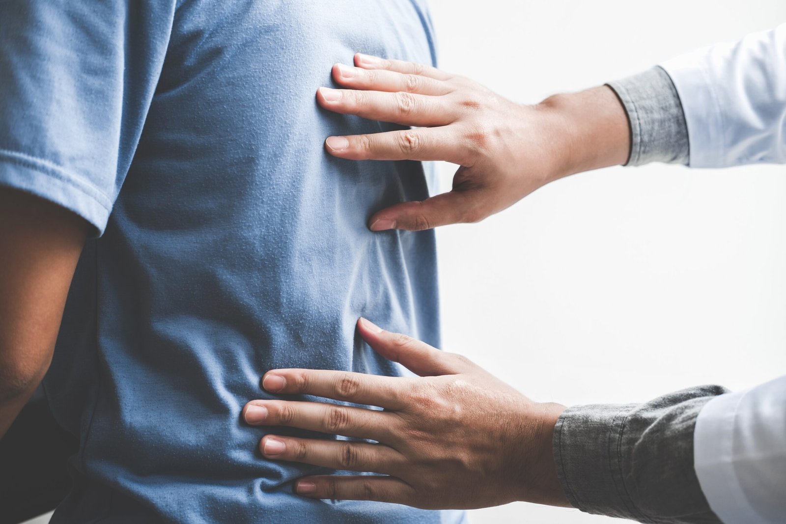 Doctor checking patient with spine to determine the cause of ill